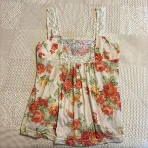 Self Esteem floral babydoll top with lace trim and button detail.